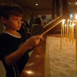Boy Lighting Candle